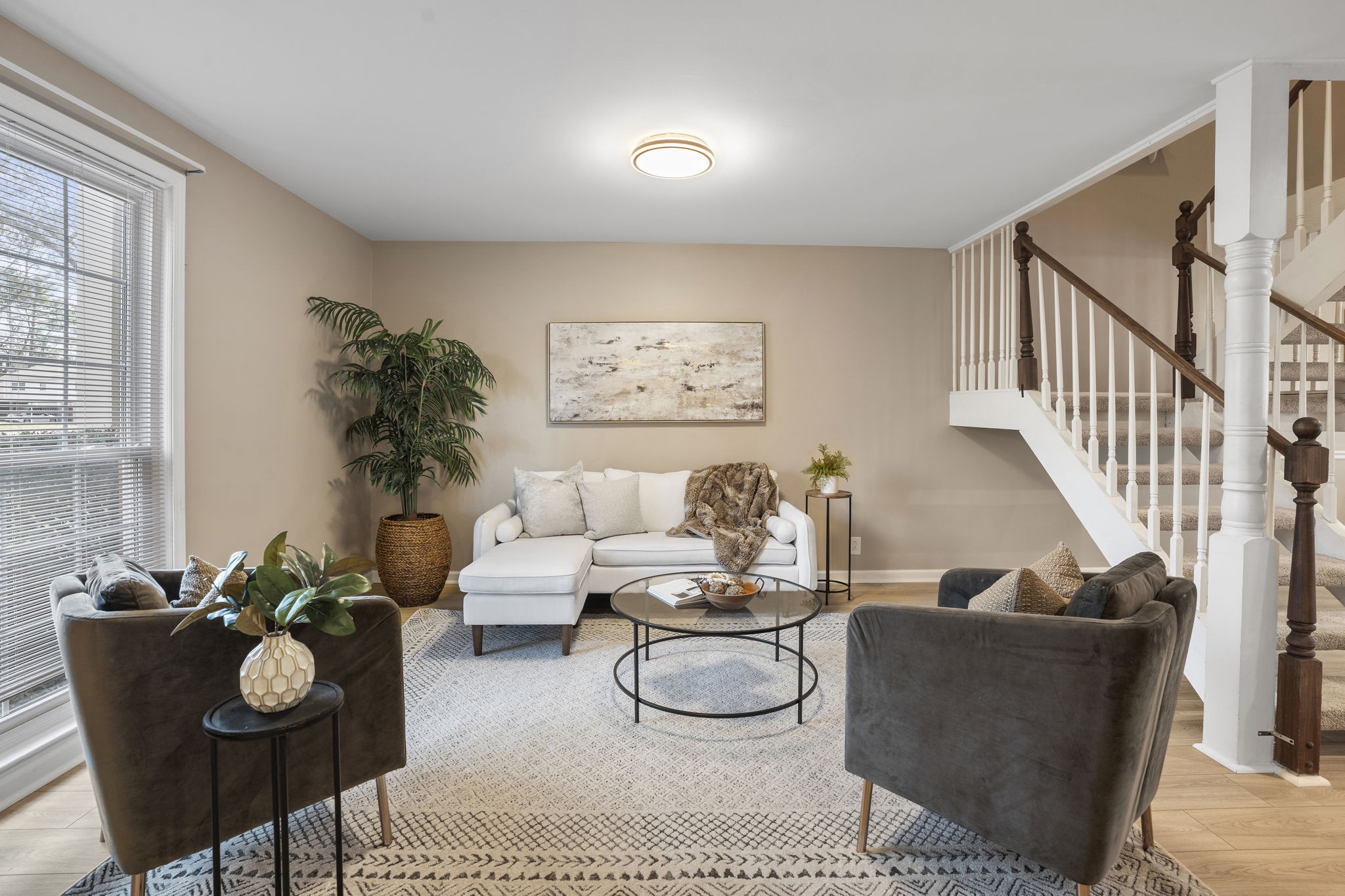 a living room with furniture and wooden floor