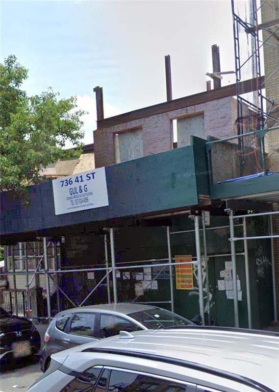 a view of a building with car parked