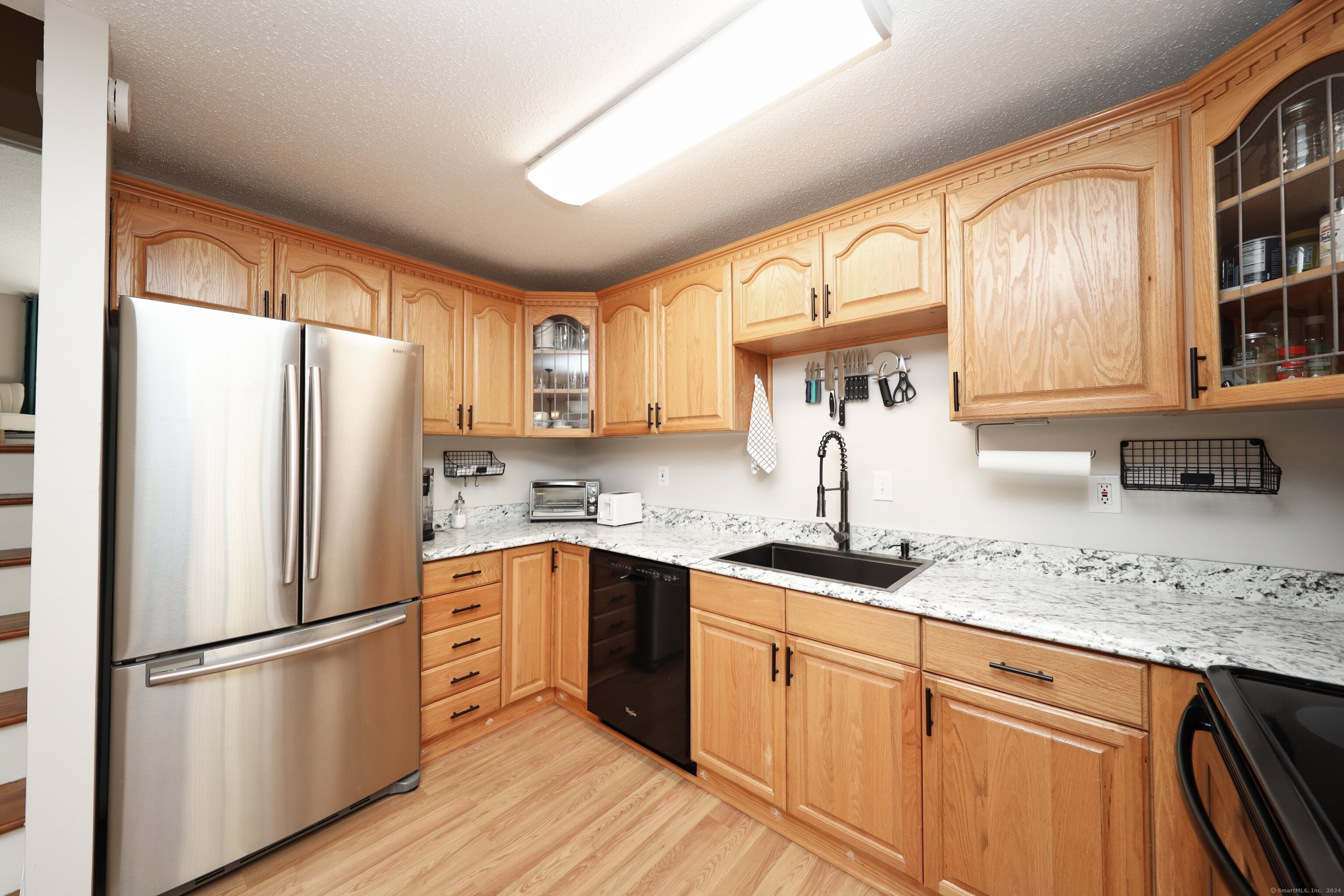 a kitchen with stainless steel appliances granite countertop a refrigerator sink and cabinets