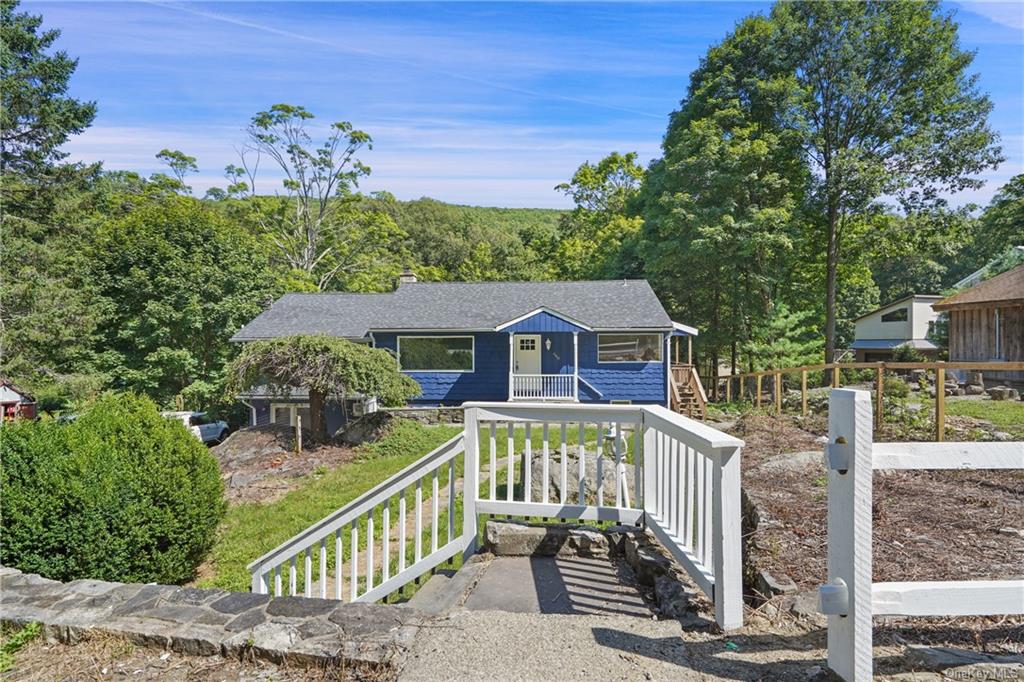 a view of a house with wooden fence