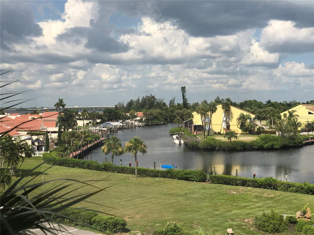 an aerial view of residential houses with outdoor space and lake view