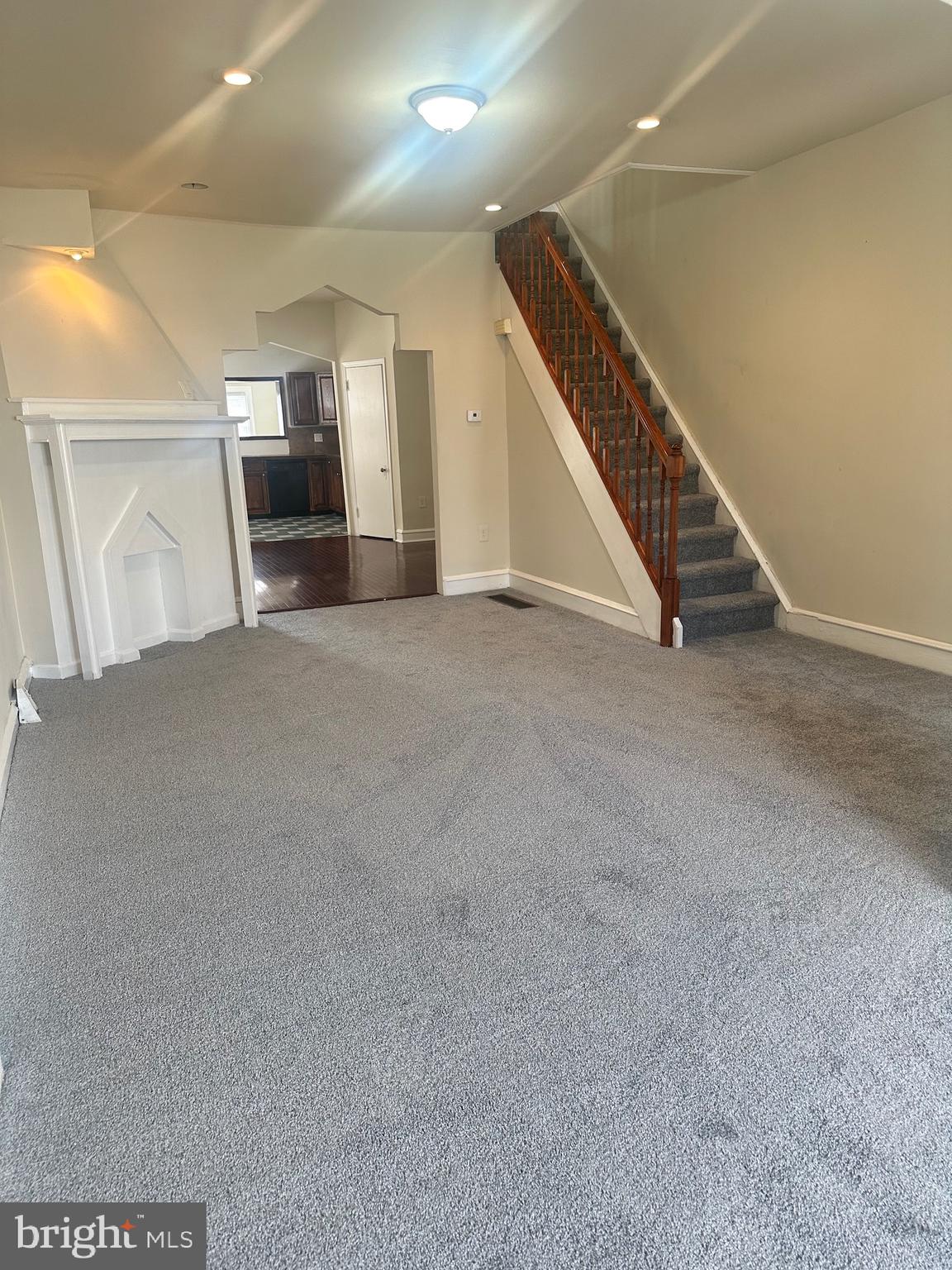 a view of an empty room with stairs