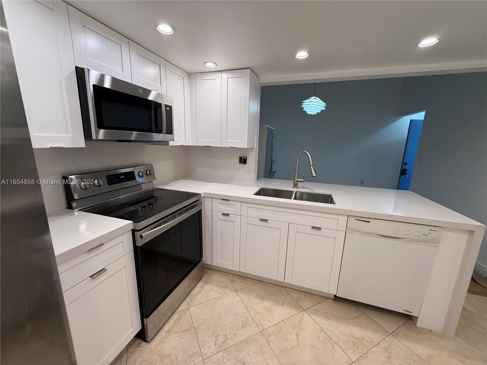 a kitchen with a sink and stainless steel appliances