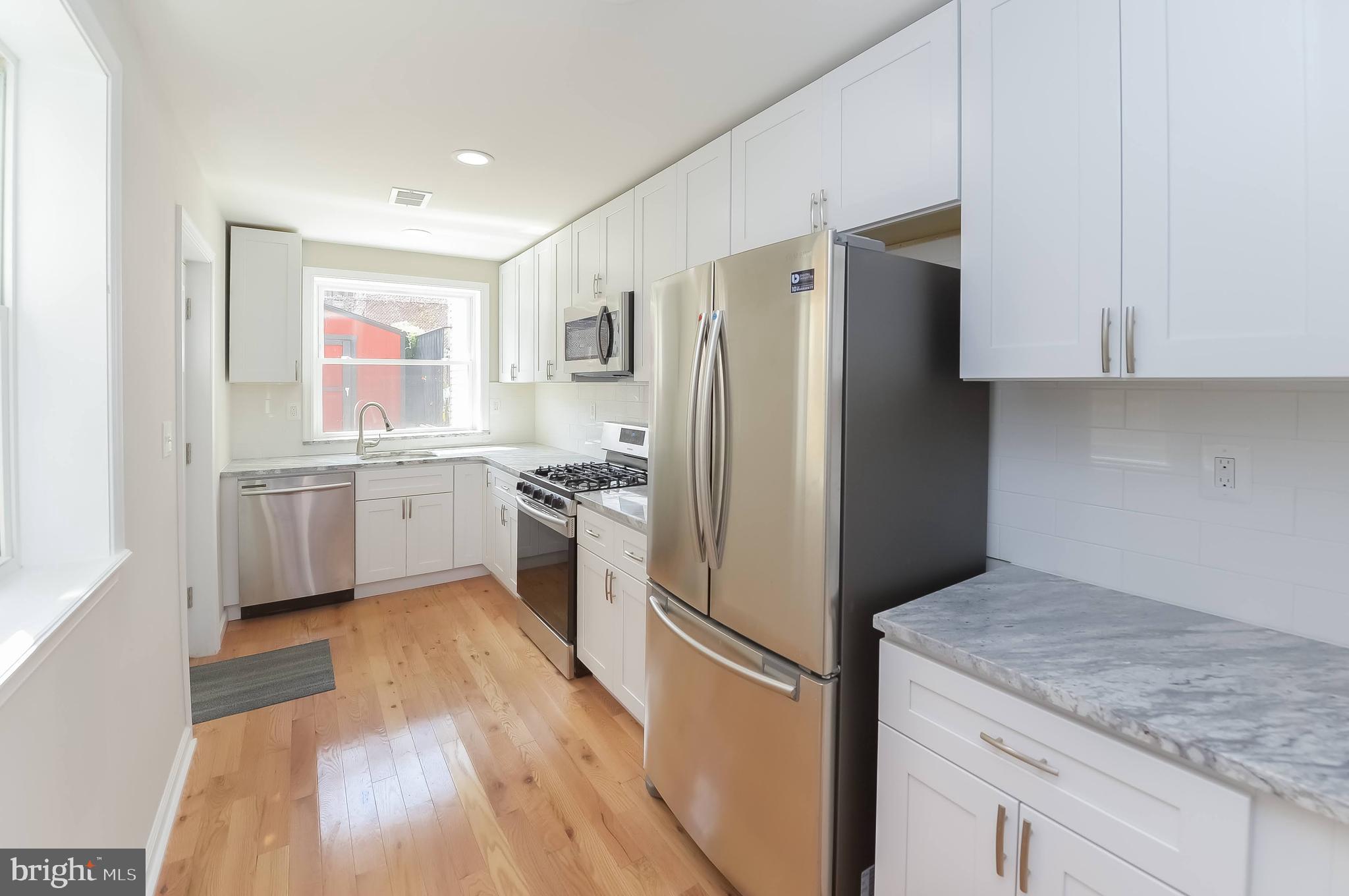 a kitchen with a refrigerator a sink and cabinets