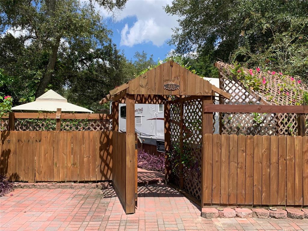 a view of a house with wooden fence