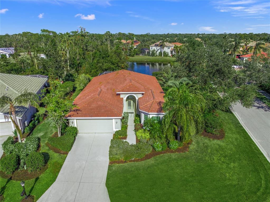 an aerial view of a house with a yard