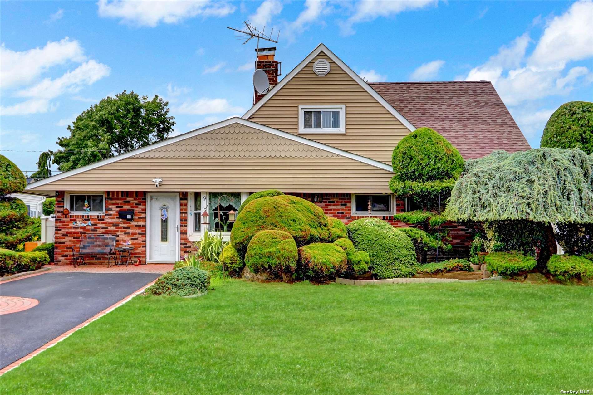 a front view of a house with a garden