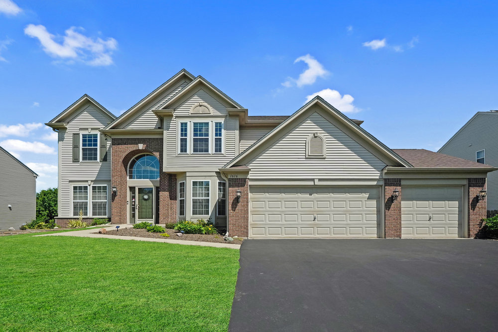 a front view of a house with a yard