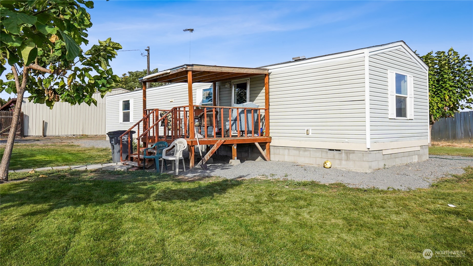 a view of a house with backyard and sitting area