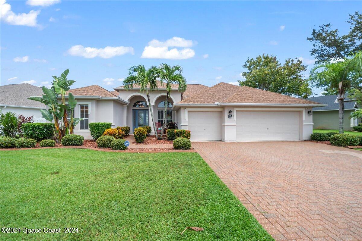 a front view of a house with a yard and garage