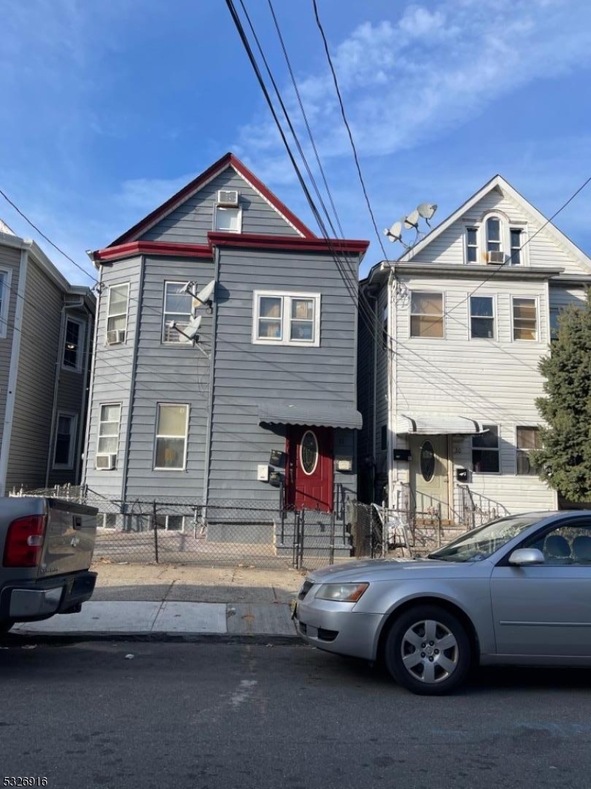 a front view of a house with parking area