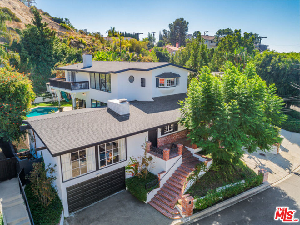 an aerial view of a house with a yard