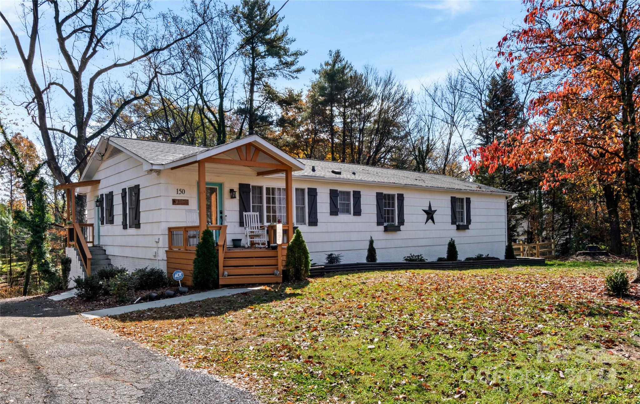 a front view of a house with a yard covered in snow