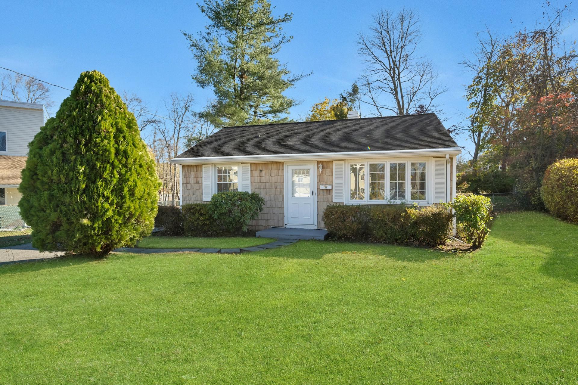 a view of a house with a yard and sitting area