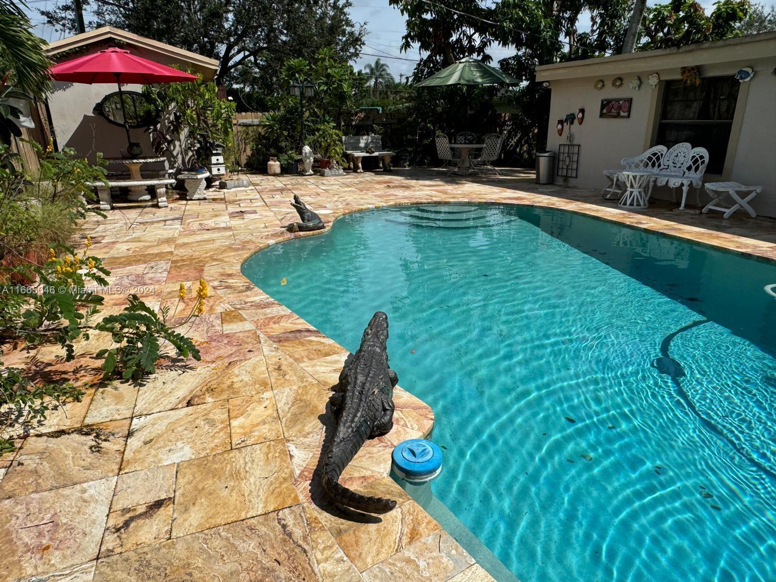 a swimming pool with outdoor seating yard and furniture