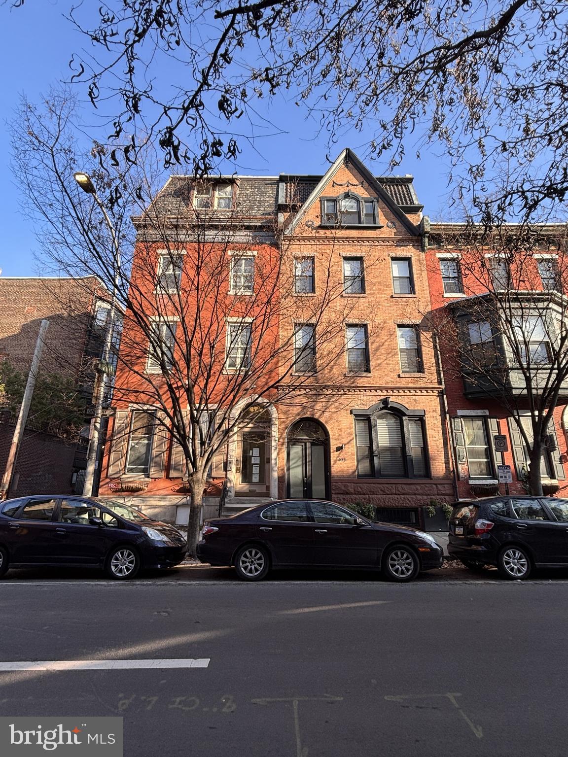 a front view of a house with a parking lot