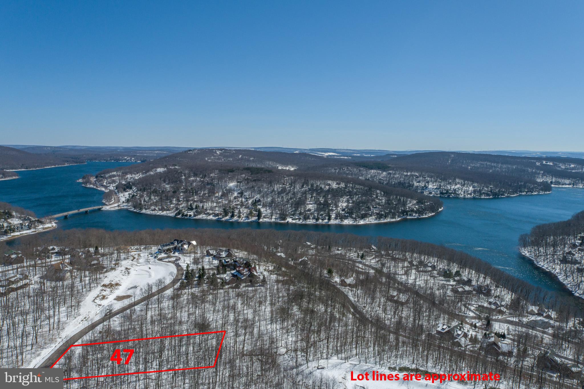 an aerial view of a house with a lake view