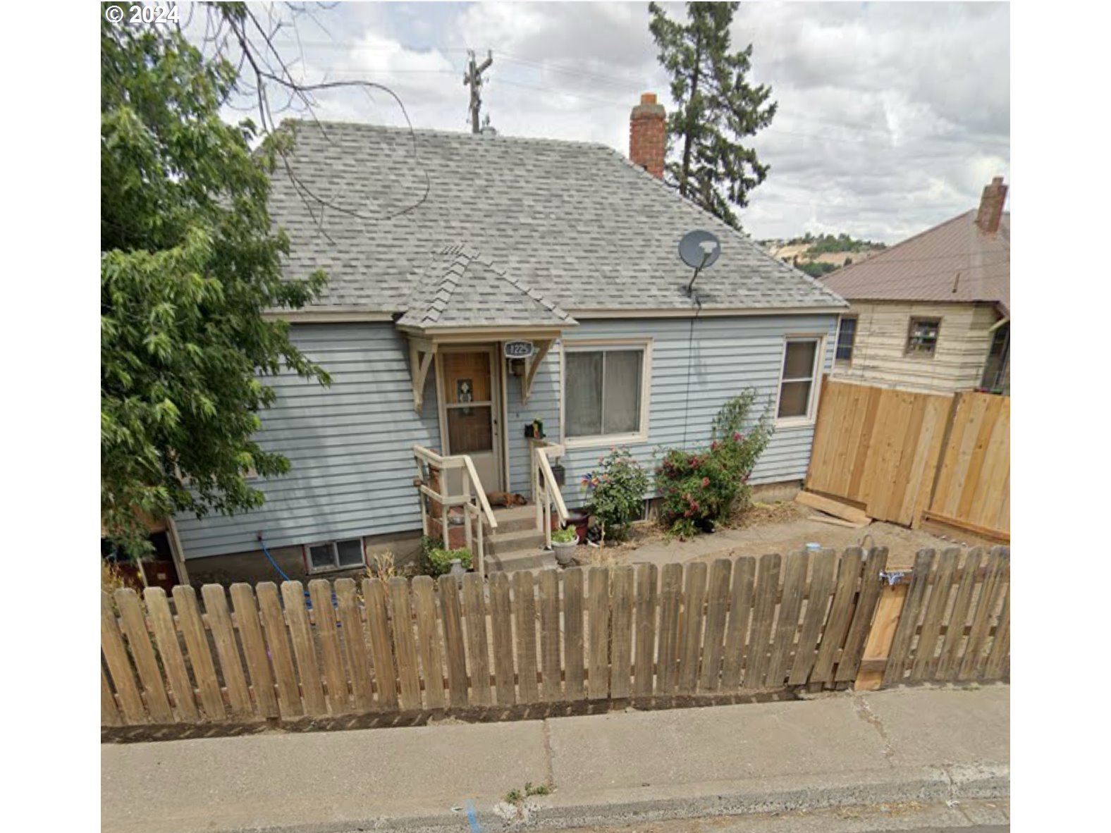 a front view of house with yard outdoor seating and garage