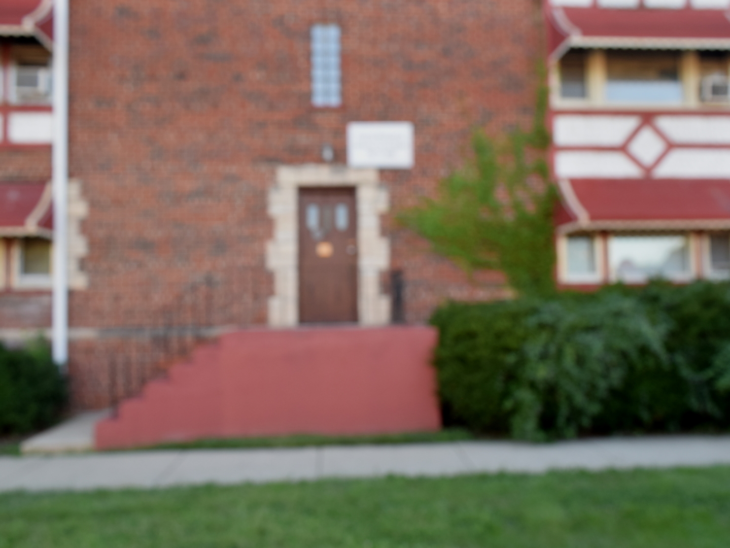 a front view of a house with a garden and yard