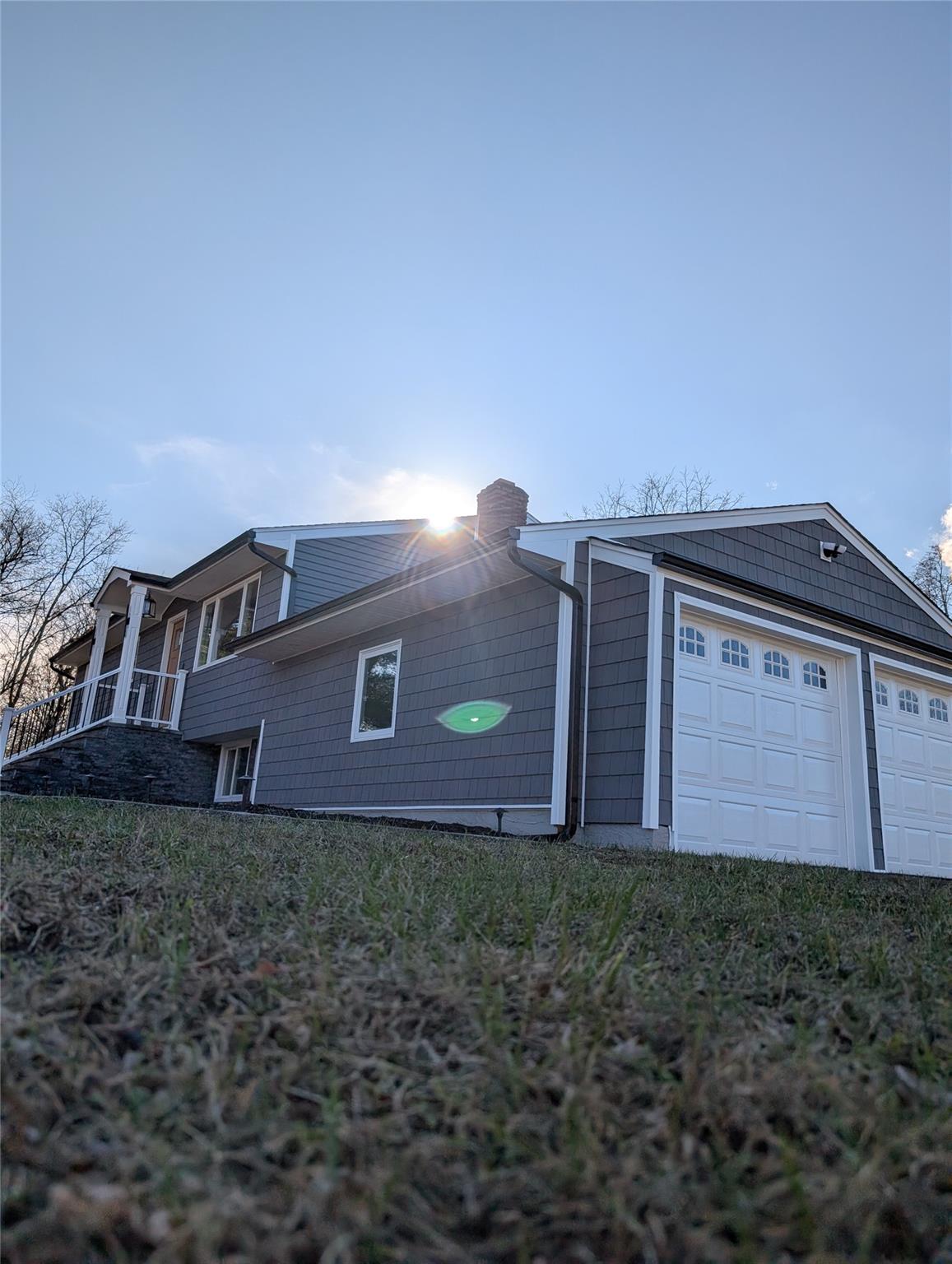 View of side of property with a garage