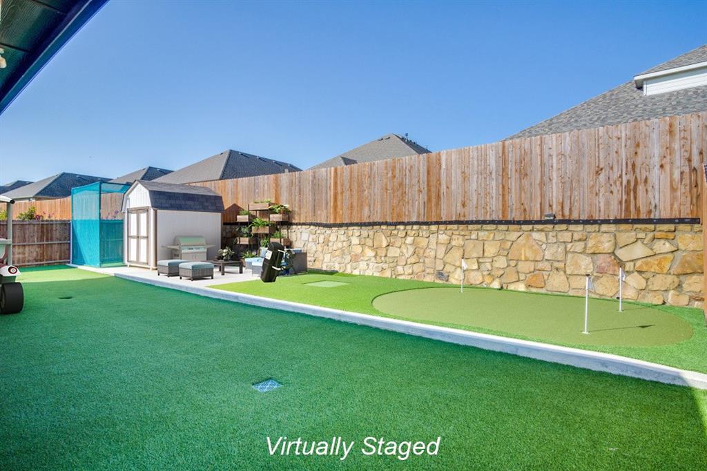 a view of a house with a yard and sitting area