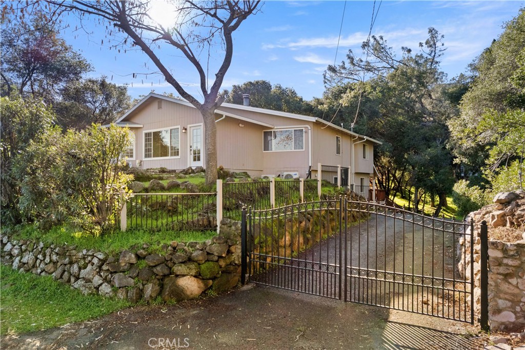 a view of a house with a small yard and plants