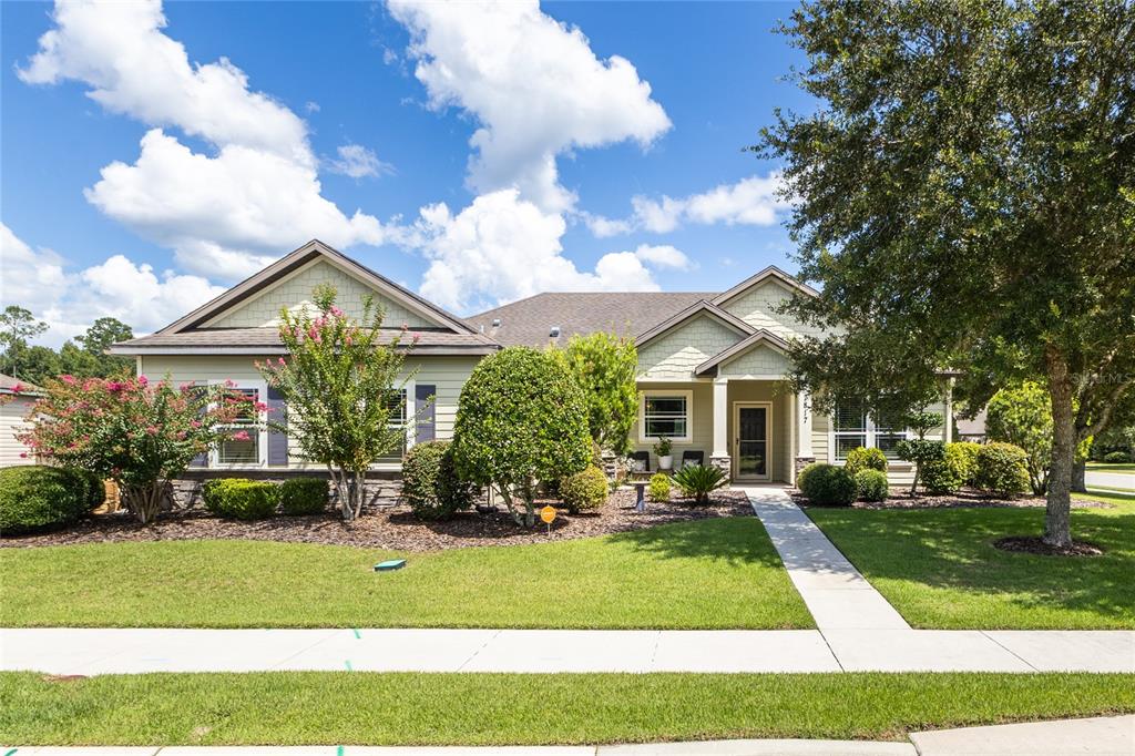 a front view of house with yard and green space