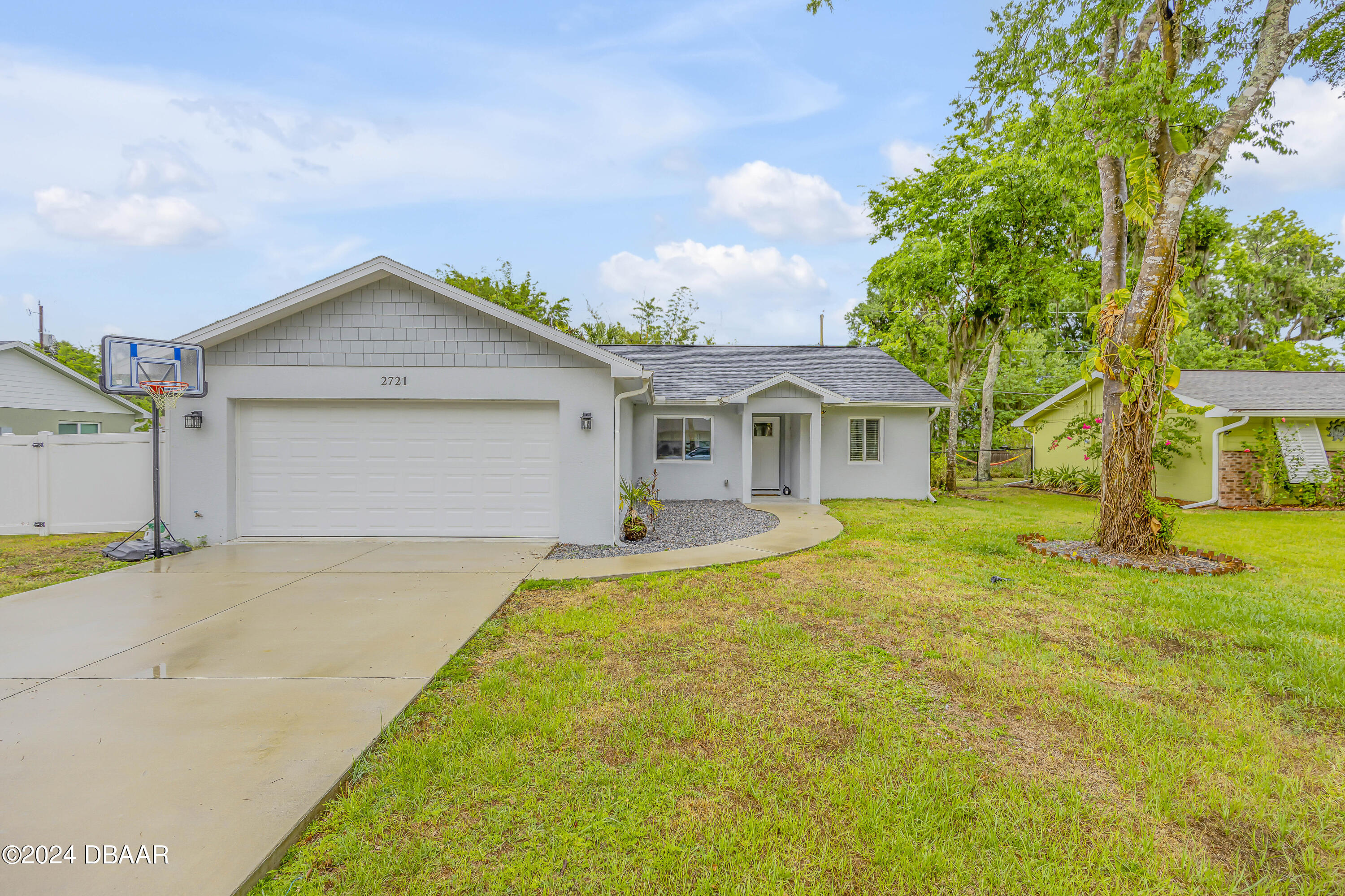 a front view of a house with yard and garage