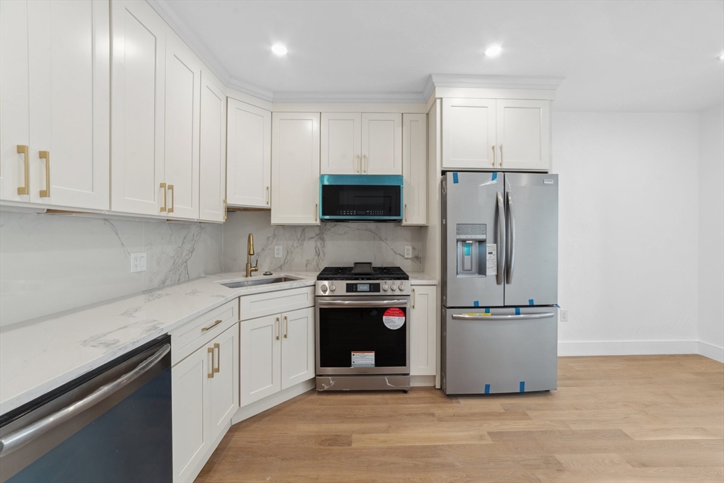 a kitchen with a stove sink and refrigerator