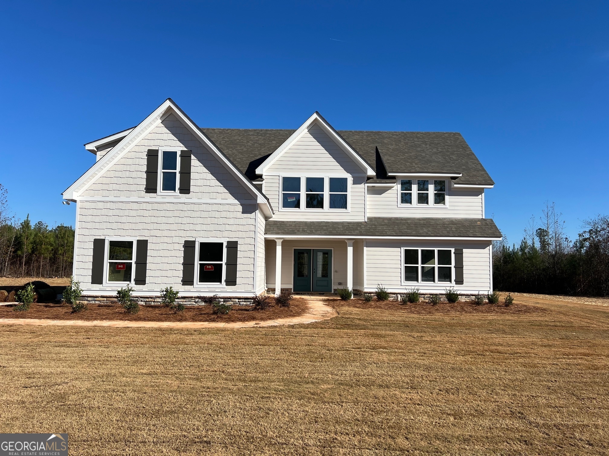 a front view of a house with a yard