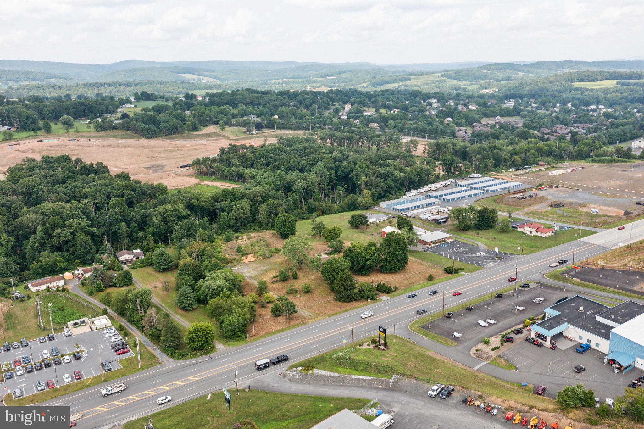 an aerial view of residential houses with outdoor space and river