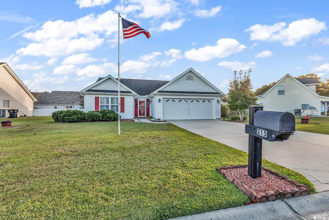 View of front of property with a garage and a fron