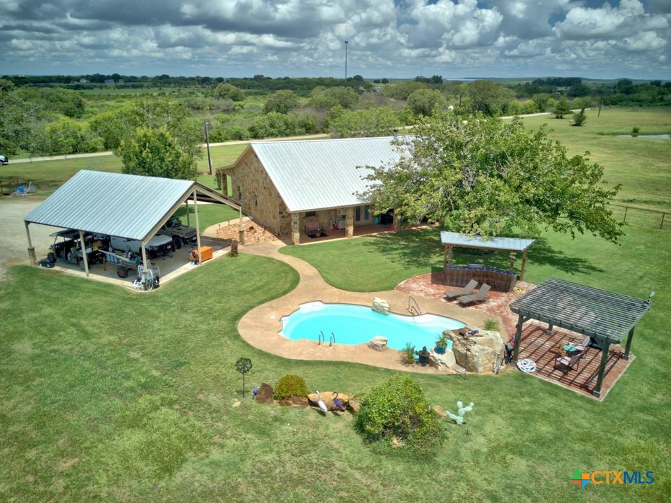 an aerial view of a house with garden space and street view