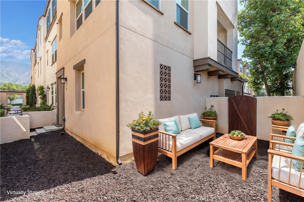 a backyard of a house with outdoor seating