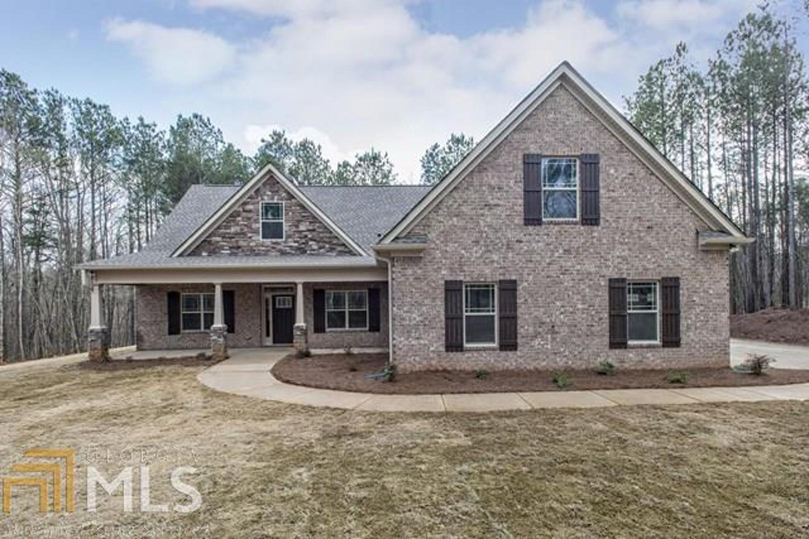 a front view of a house with yard patio and fire pit