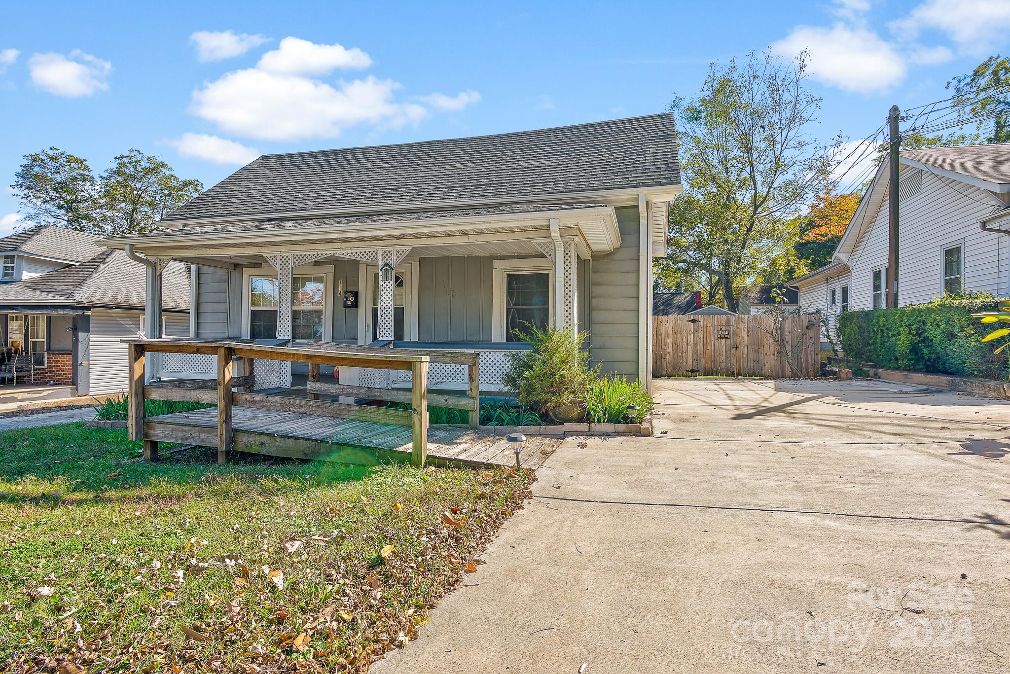 a front view of a house with a yard table and chairs