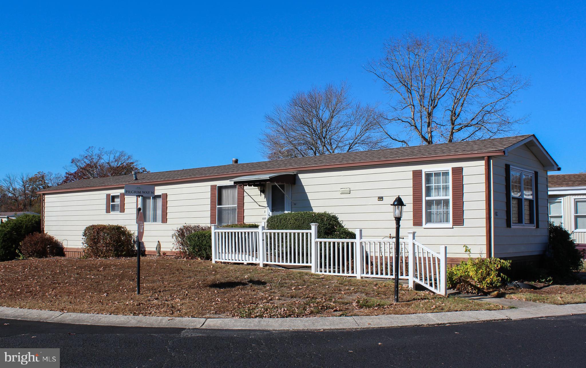 a view of a house with a yard and large tree