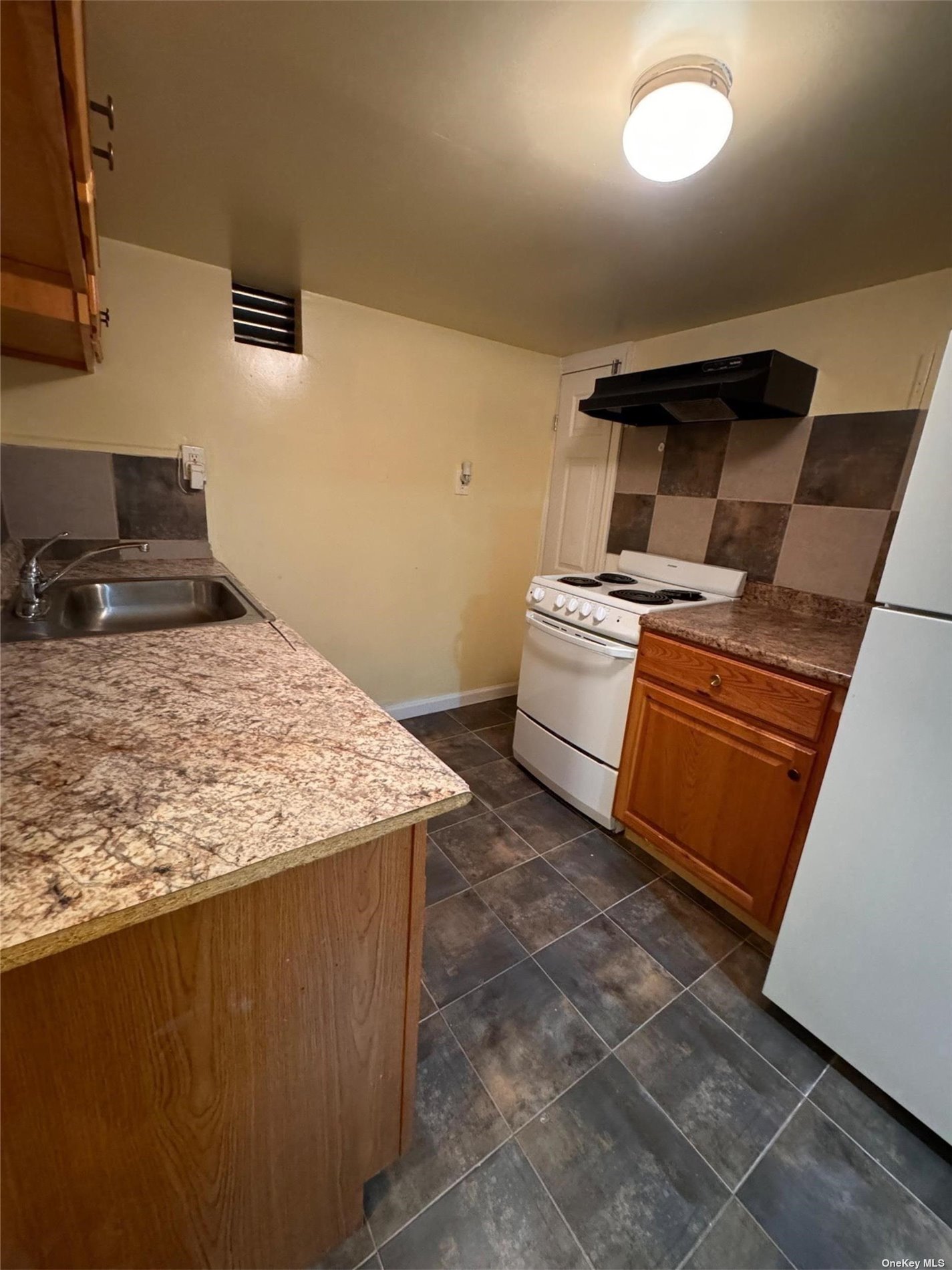 a kitchen with a stove and a sink