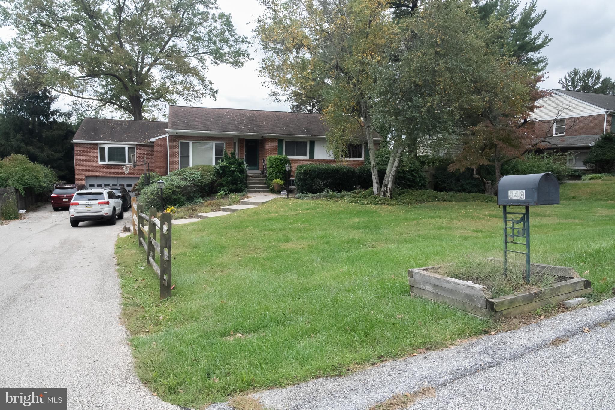 a front view of a house with a yard table and chairs