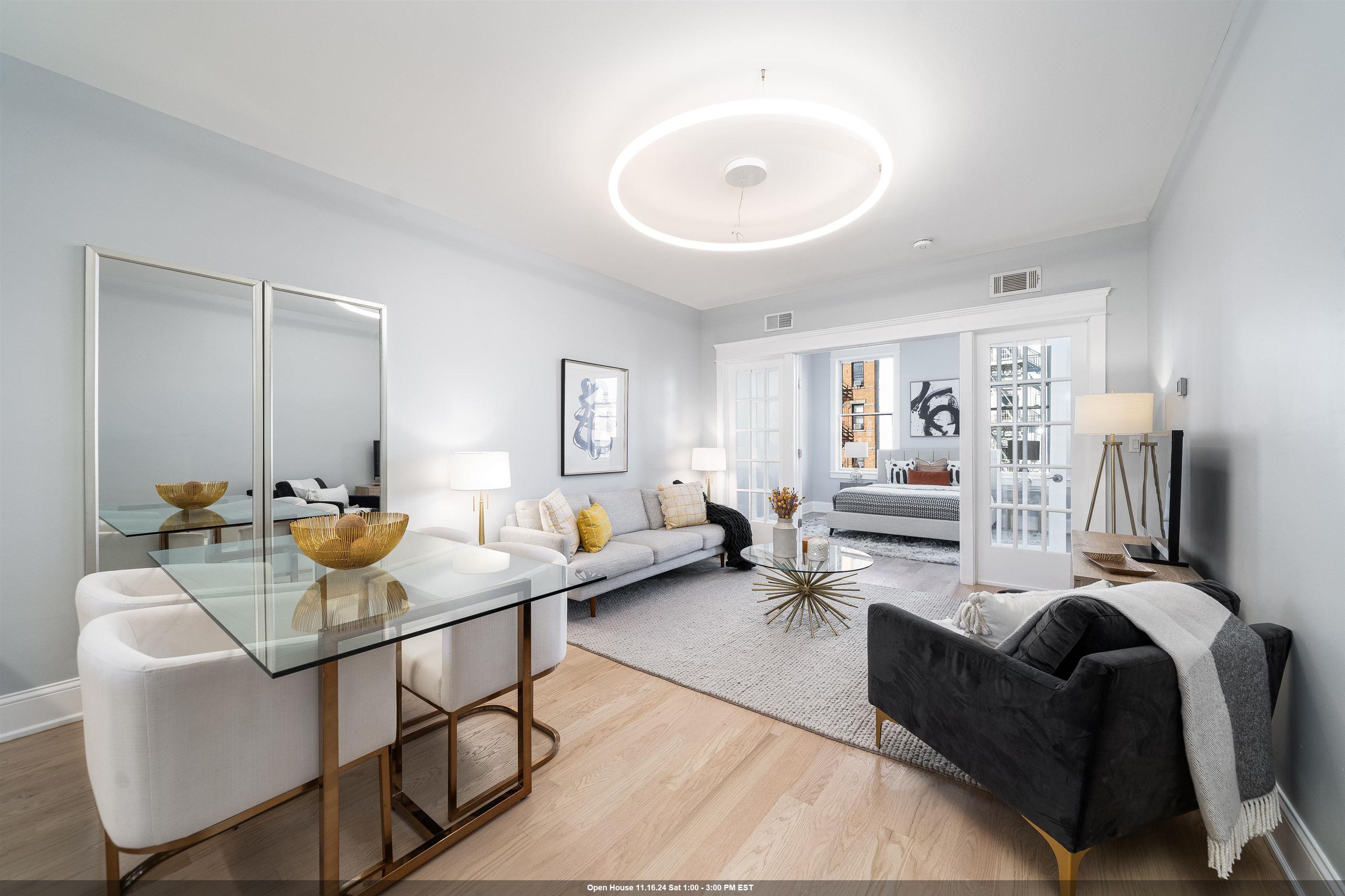 a living room with furniture and a wooden floor