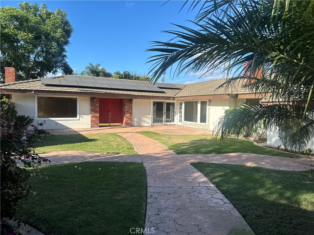 a house with palm tree in front of it