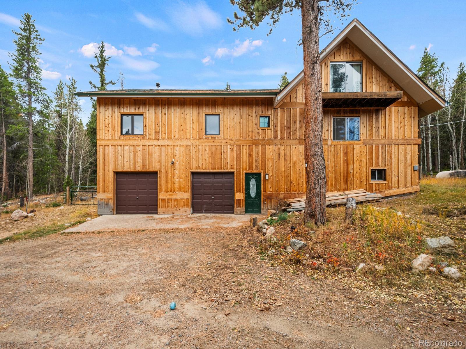 a view of house with backyard and deck