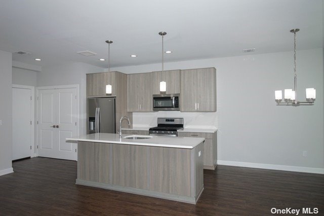 a kitchen with kitchen island white cabinets and stainless steel appliances