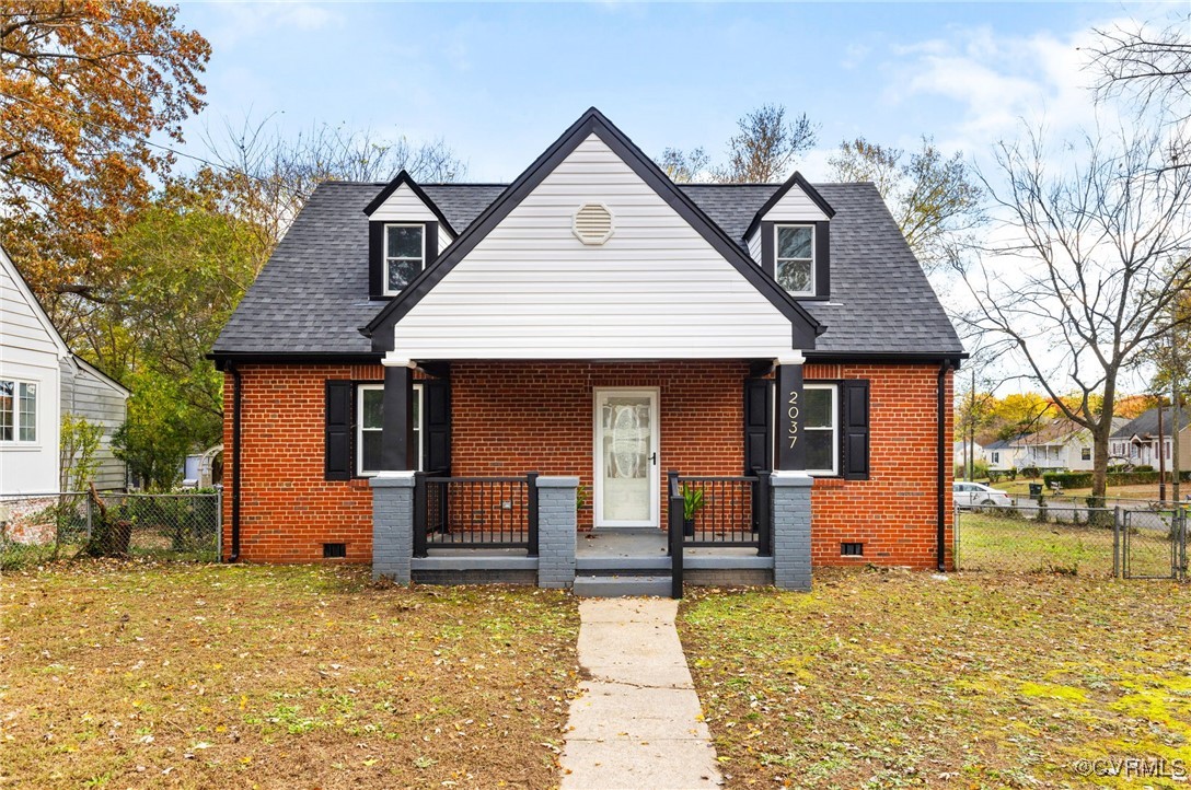 View of front of home featuring a porch and a fron