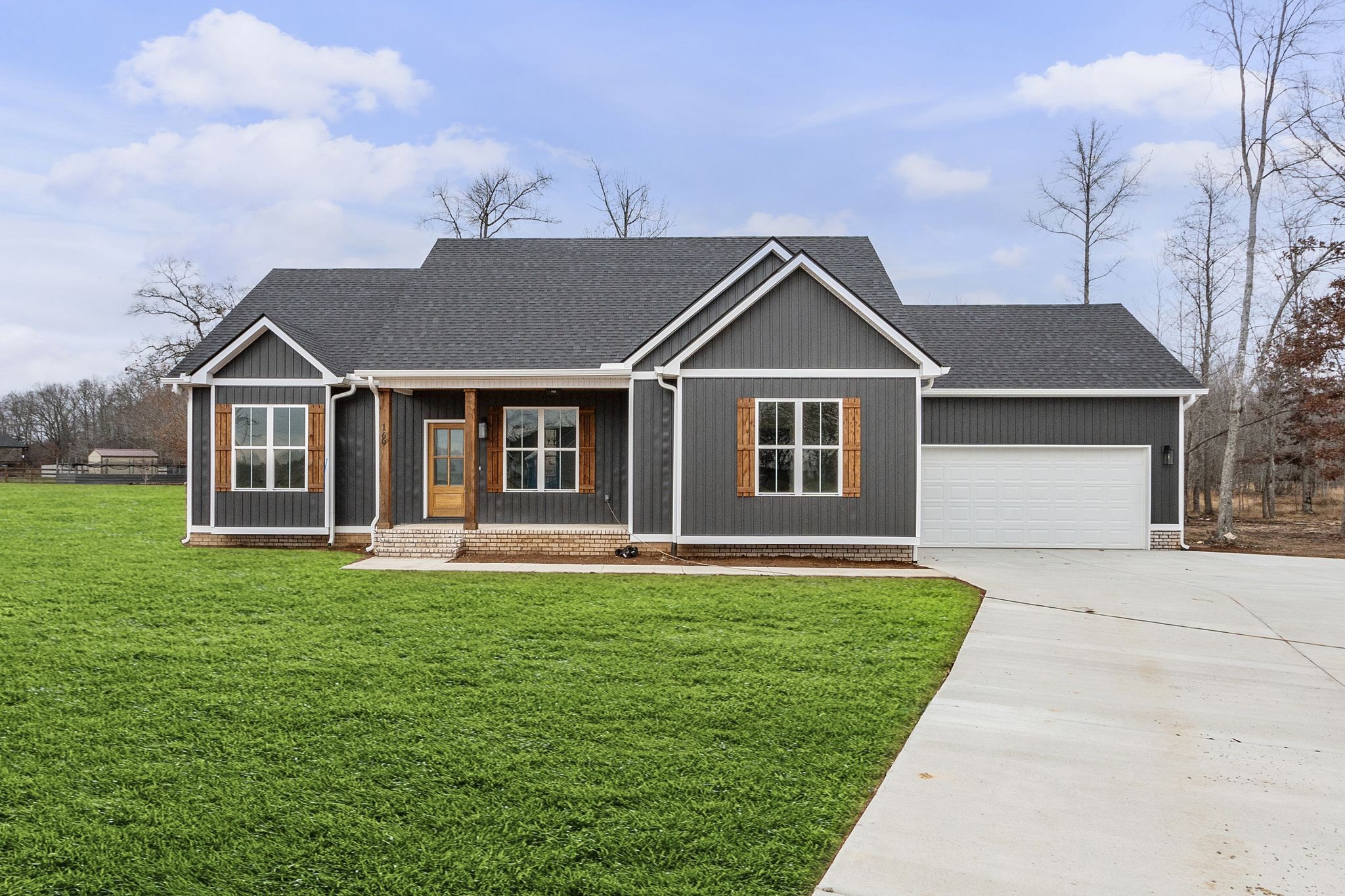 a front view of a house with a garden and yard