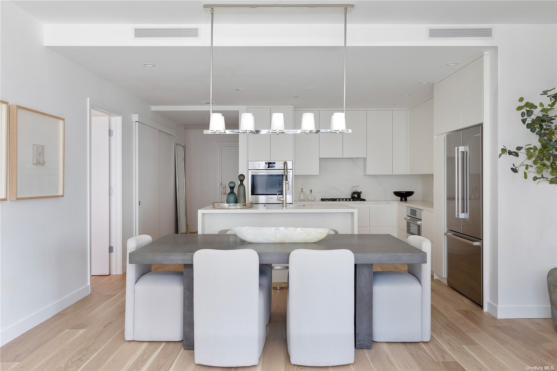 a kitchen with kitchen island stainless steel appliances a sink and cabinets