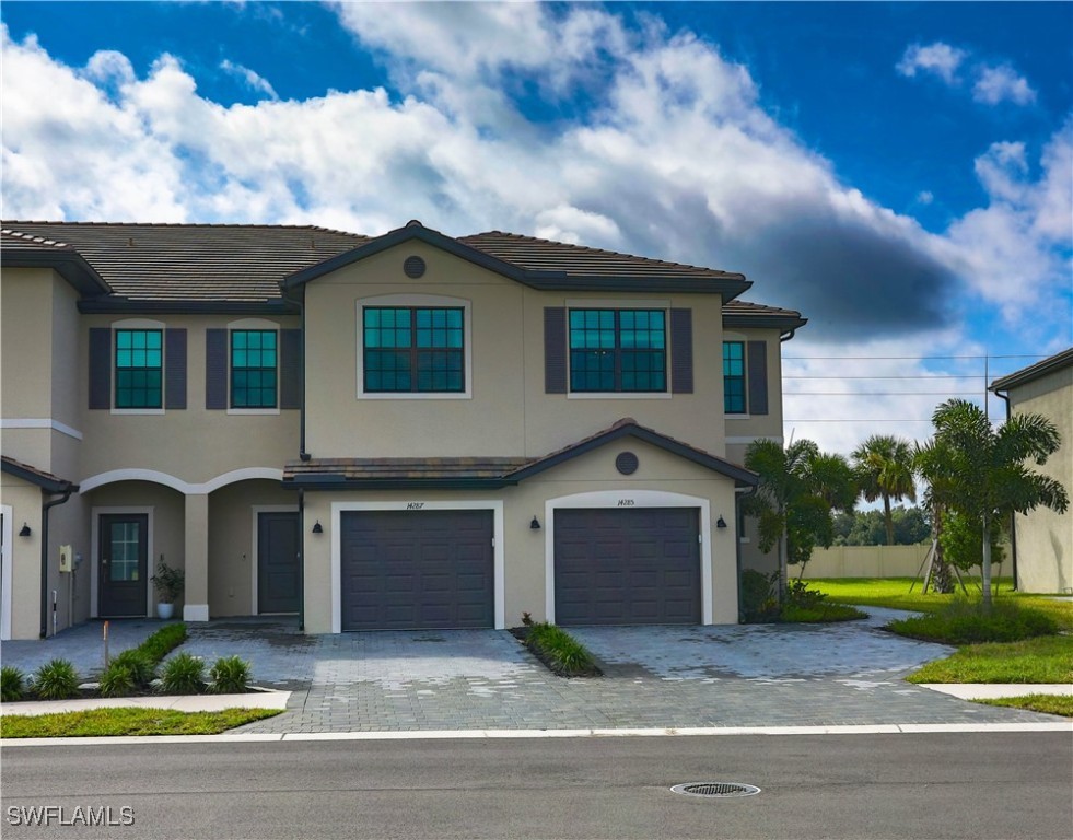 a front view of a house with a yard and garage