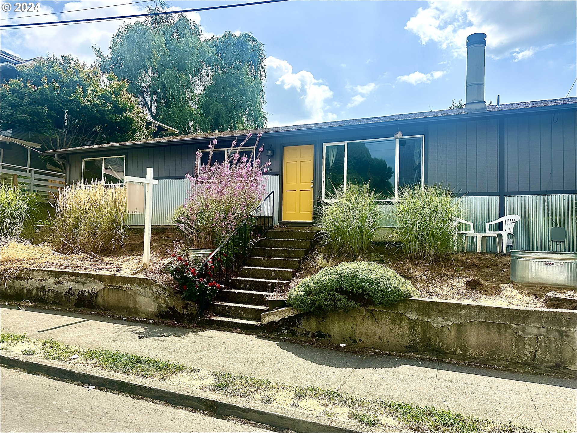 a front view of a house with garden