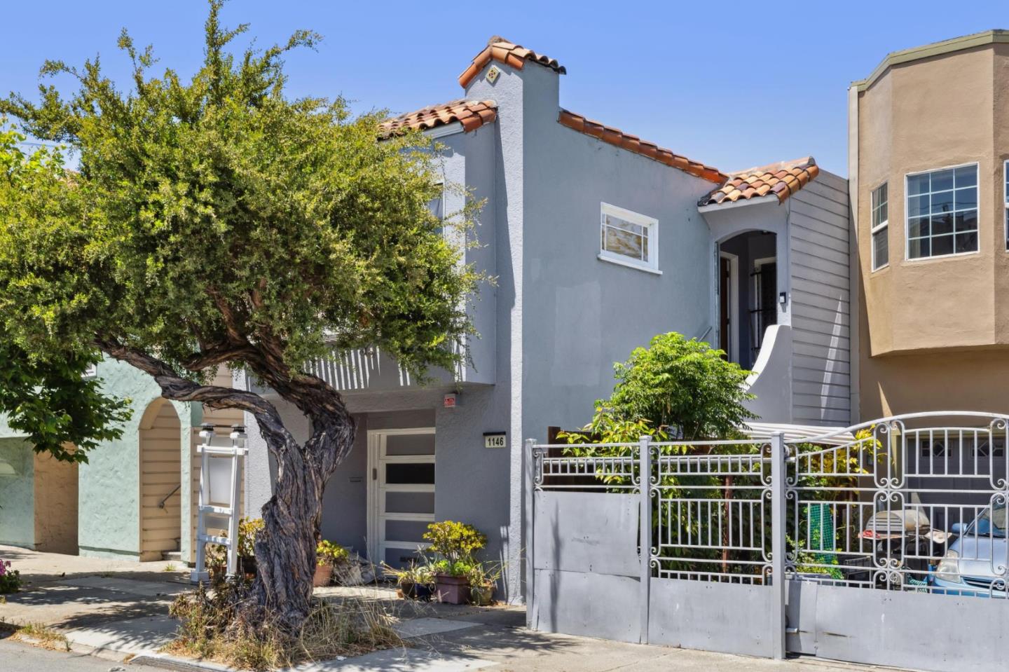 front view of a house with a tree