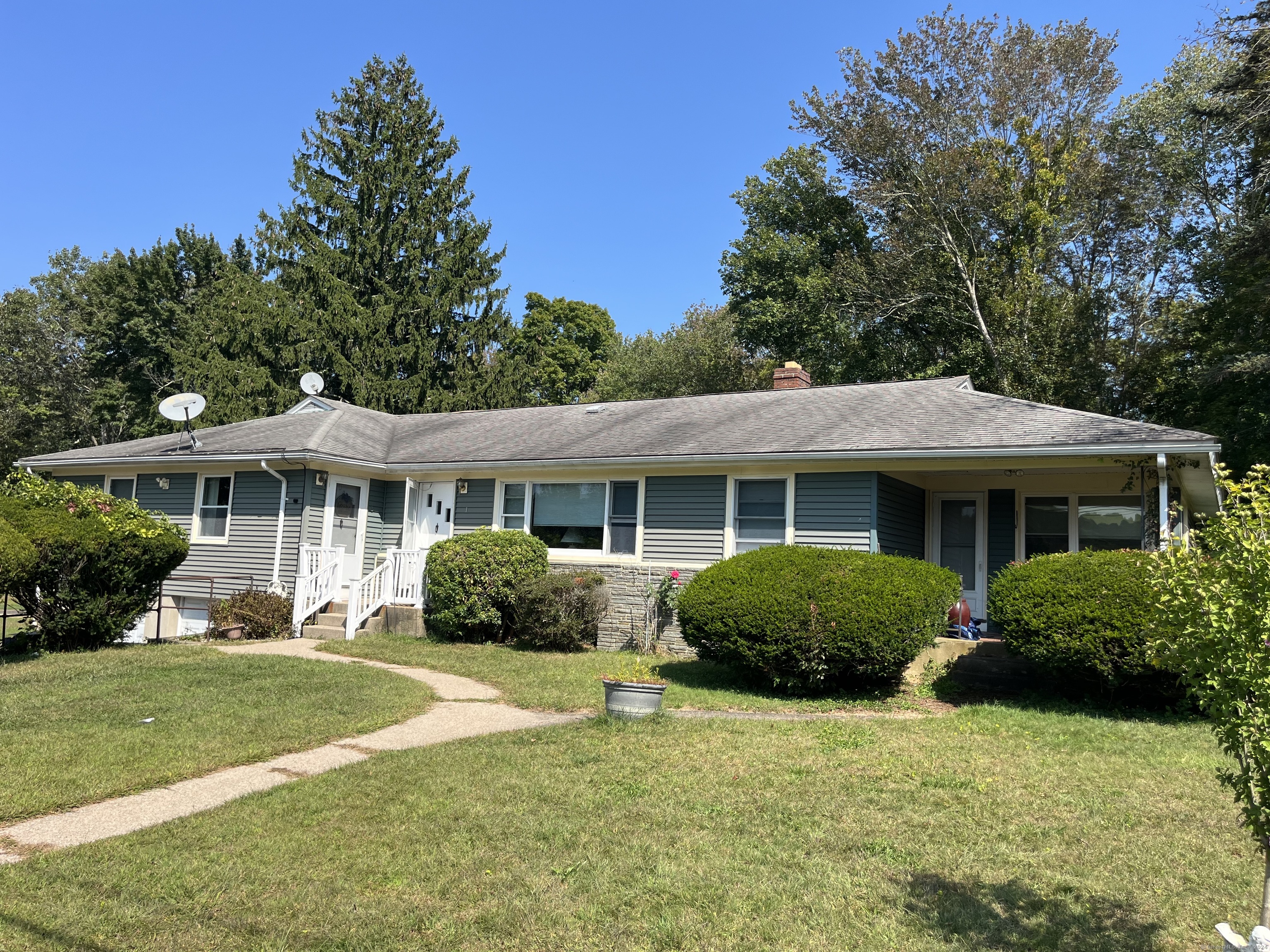 a front view of a house with a garden